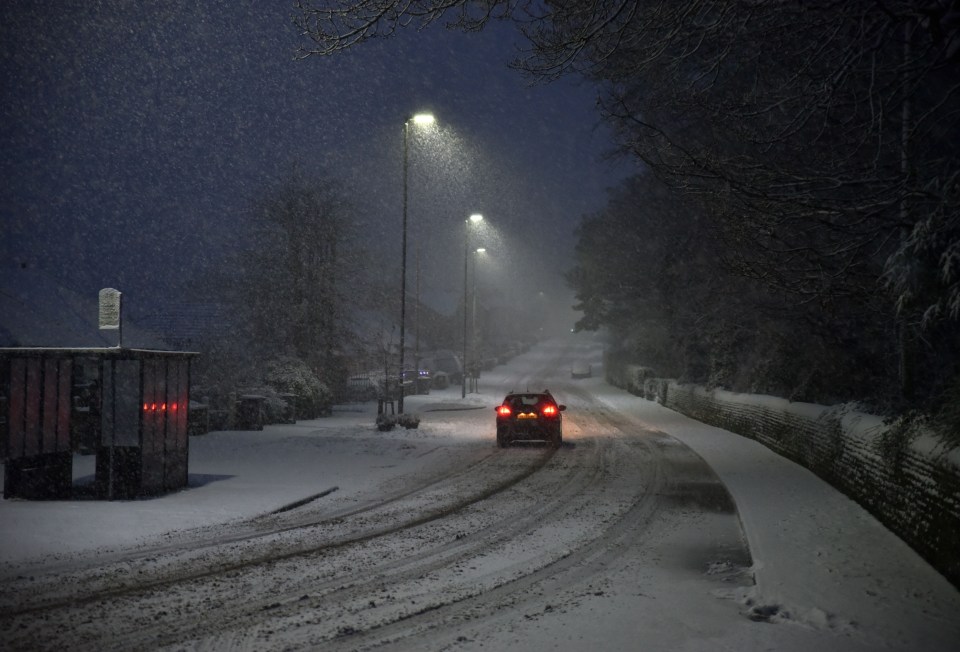 In Sheffield, a driver tackles streets covered by snow