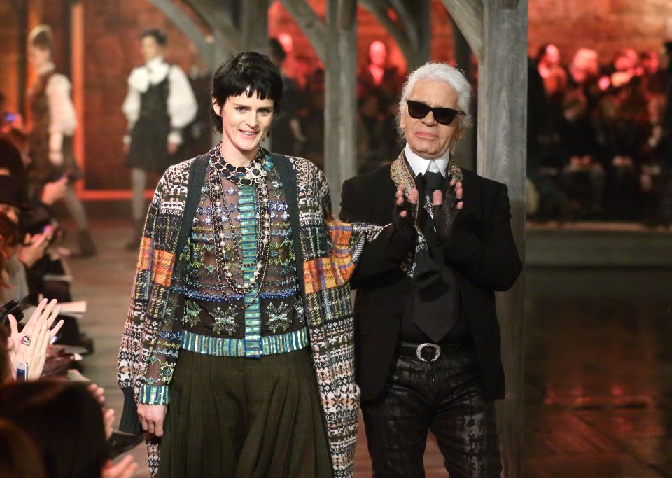 Stella Tennant and Karl Lagerfeld walk the runway at the CHANEL: Metiers d'Art fashion show in 2012