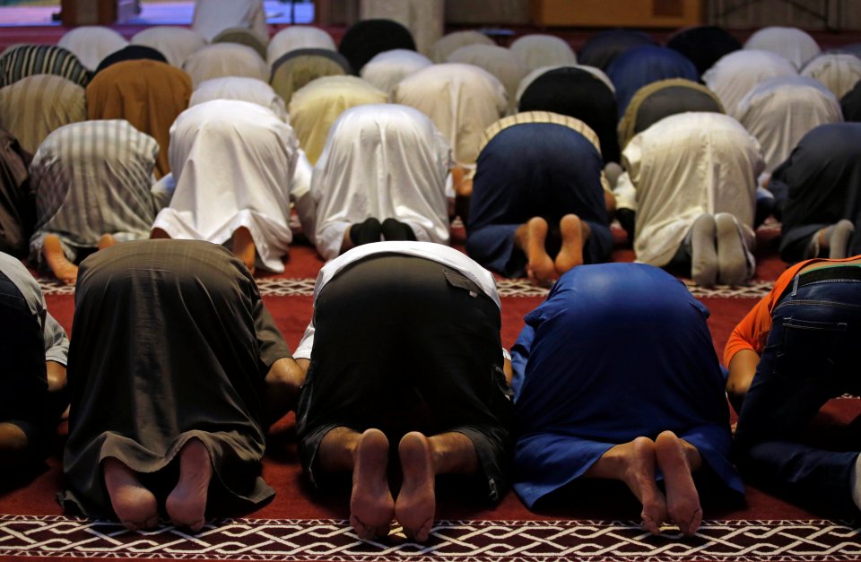 Members of the Muslim community during Friday prayers inside a mosque in Frejus, France