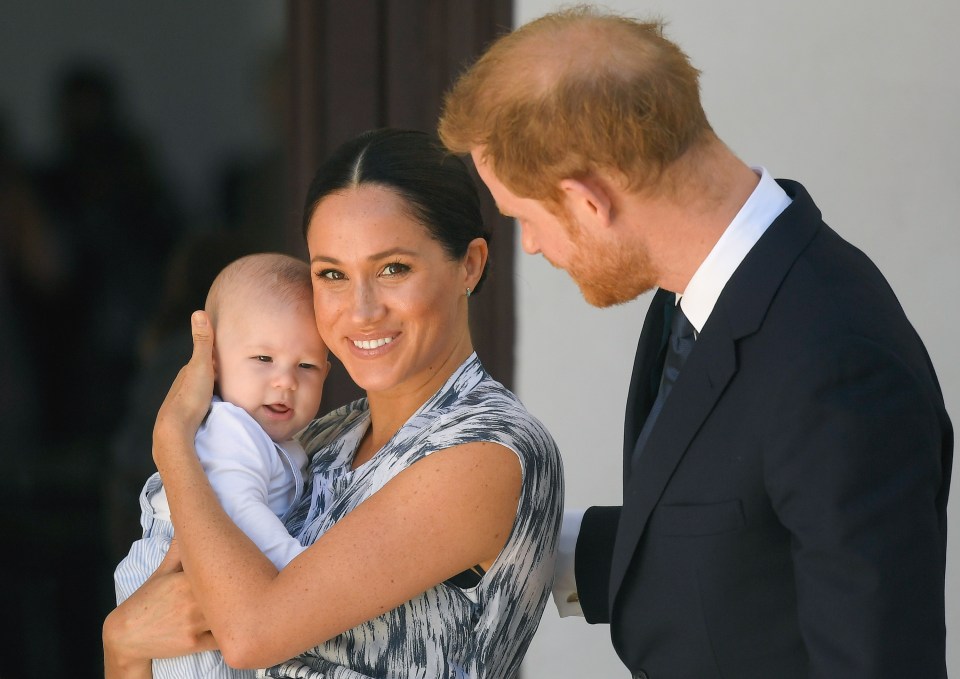 The couple pose with baby Archie and their two dogs 