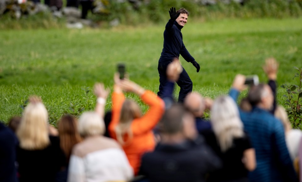 Tom Cruise waves to an audience as he films Mission: Impossible 7 in Norway in September