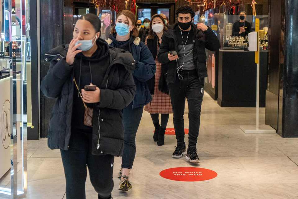 Customers enter the Selfridges department store as it reopens for general retail in London