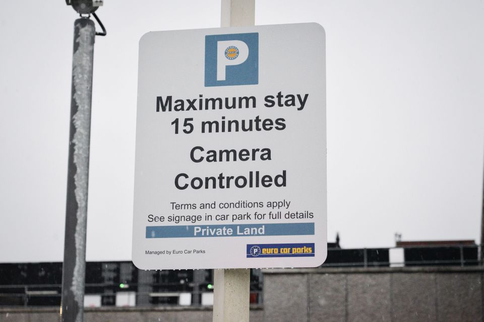 A sign says fines will be given to those who spend more than 15 minutes at the garage  - but driver ssay it is difficult to spot