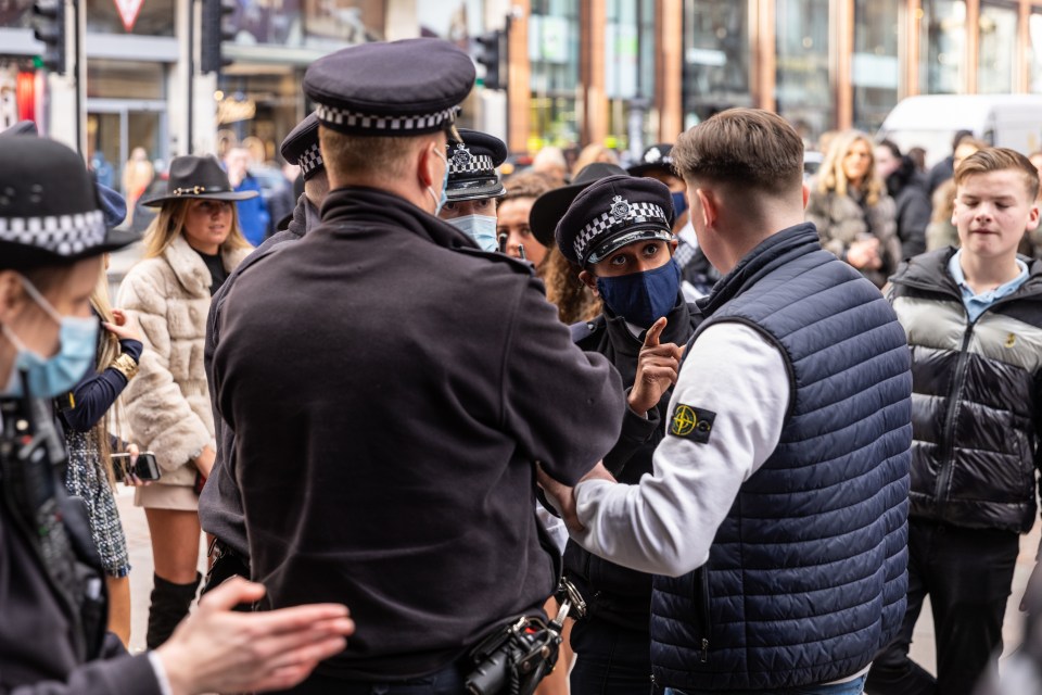 Cops confronting the shoppers outside Harrods, London