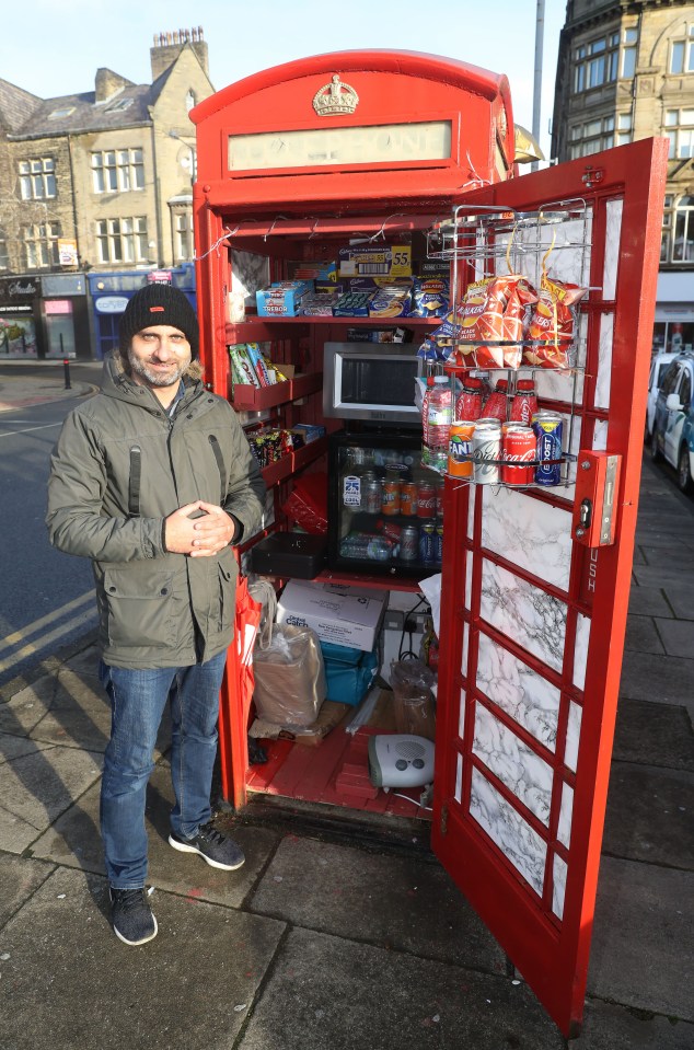 Nizam Din, 40, is selling hot drinks, snacks, sweets and pop from the old iconic phone booths