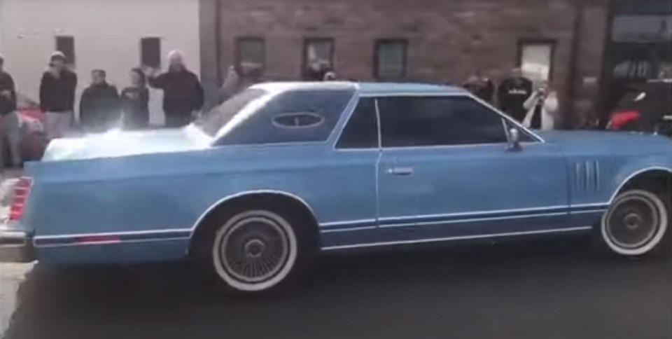 Frontman Jeremy Clarkson can be seen in a blue Lincoln