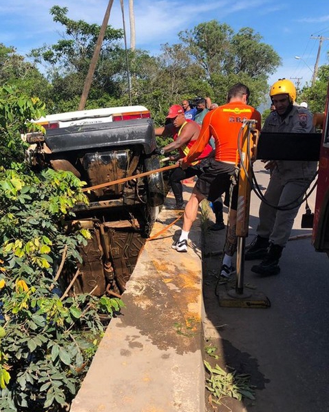 The car fell into a river as the driver tried to dodge a cyclist, witnesses said