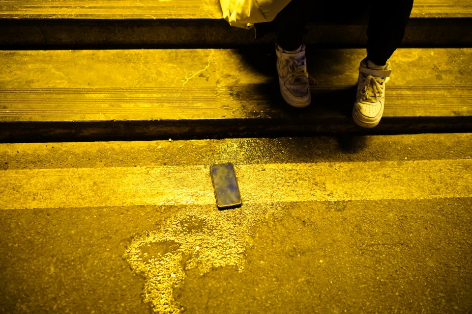 Evidence of a heavy night? Vomit and a phone can be seen on the street