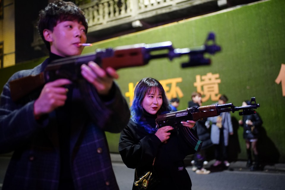 The couple poses with toy guns as they enjoy their night out 