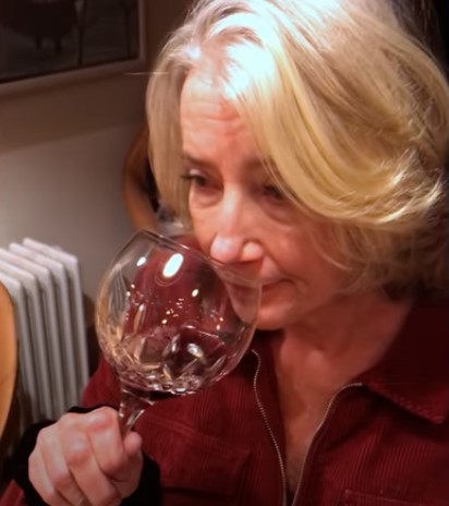 Emma Thompson is seen sniffing a glass of wine a few times 