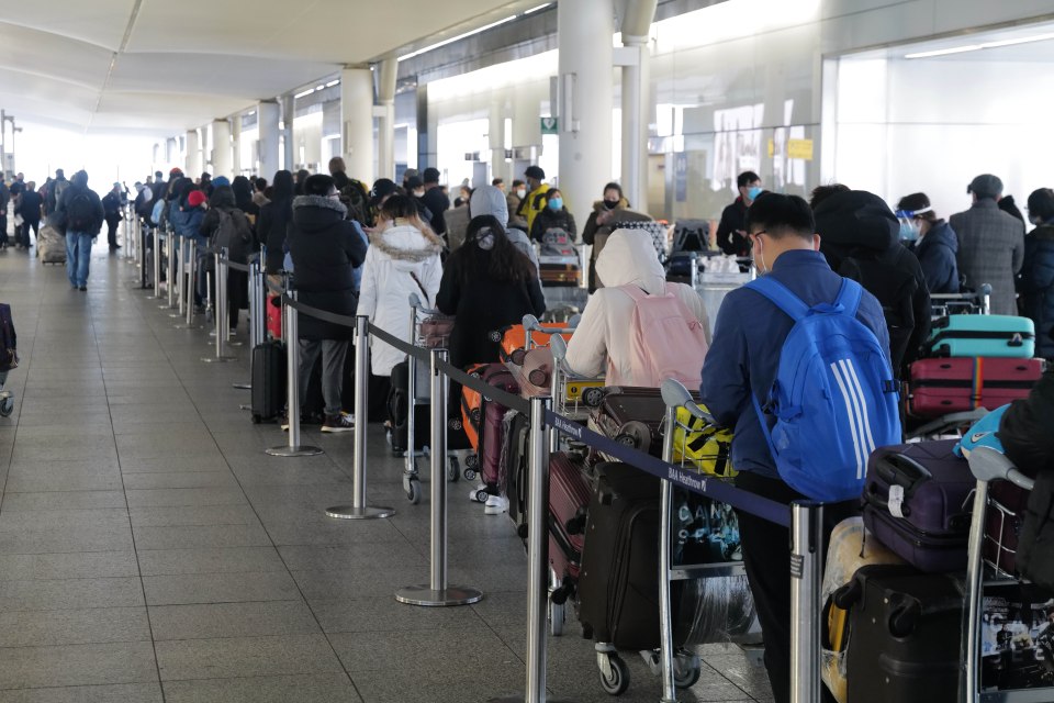 Passengers were pictured packed into Heathrow terminal 2 this morning