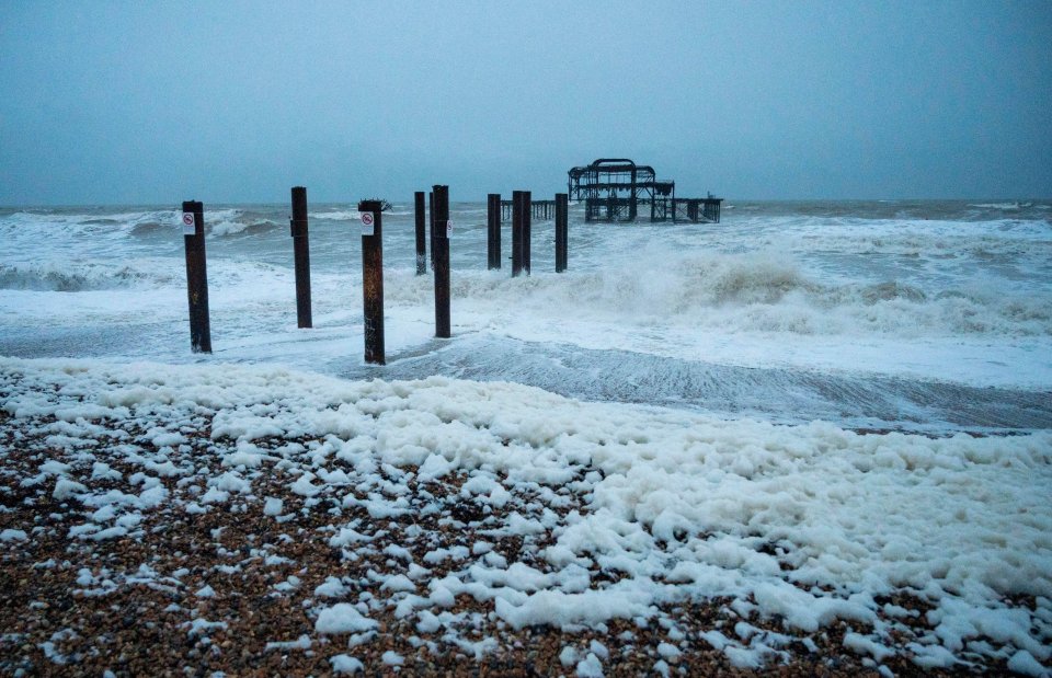 Strong gusts of winds also blew foam onto the beach in Brighton