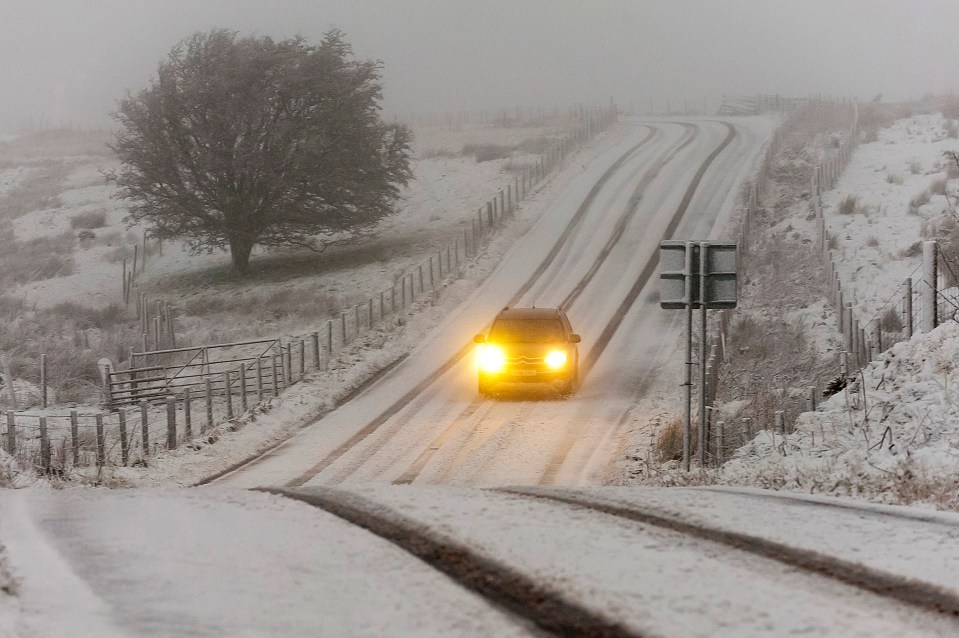 A car makes its way along a snowy road in Builth Wells, Powys, Wales 