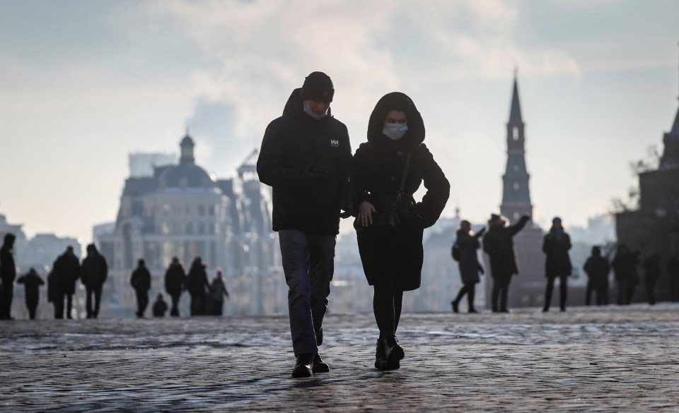 People wearing masks walk in Moscow today