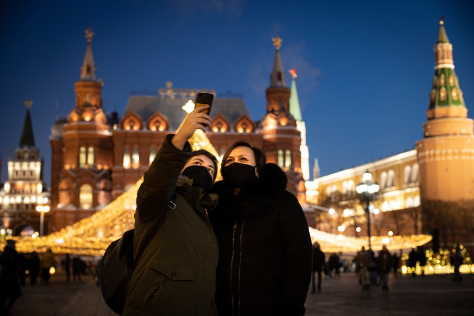 Two people pose for a selfie near Red Square in Moscow today