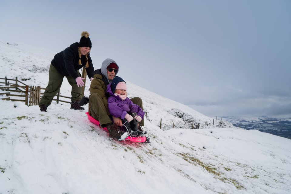 A family were seen sledging down hills in the Peak District 