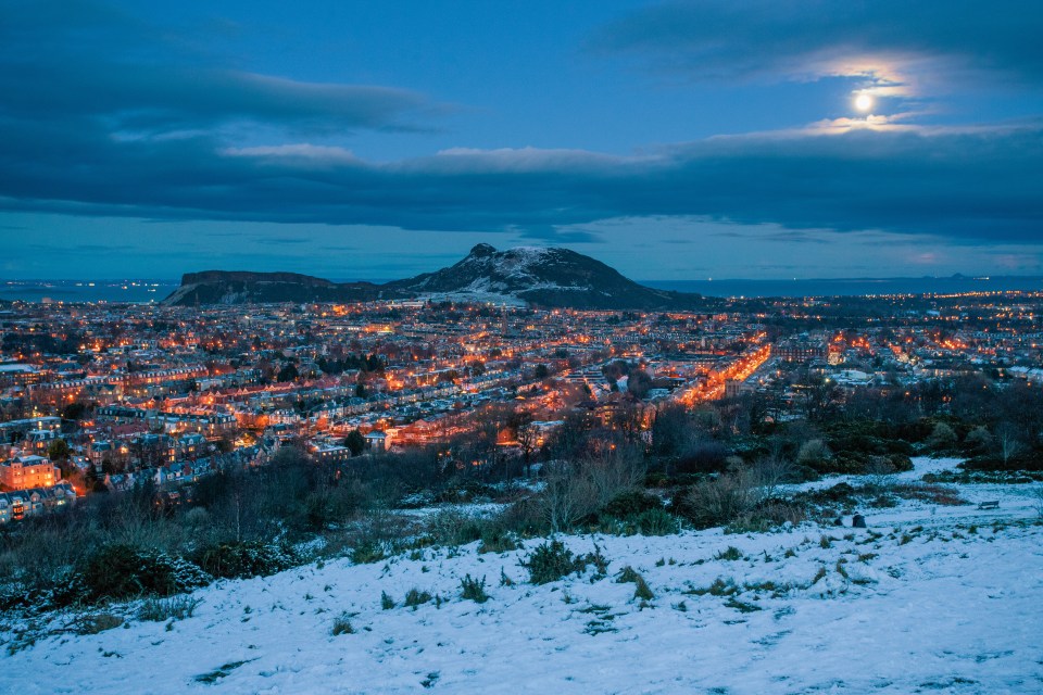 The Cold Moon is pictured rising over Edinburgh on Tuesday evening