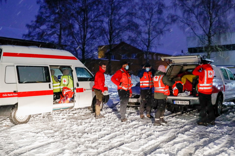 Rescue workers from the Red Cross prepare for a rescue operation at the site 