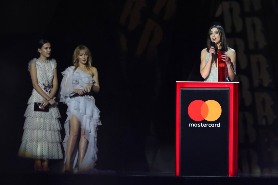 Millie Bobby Brown (left) and Kylie look on as Dua collects her 2018 BRIT Award