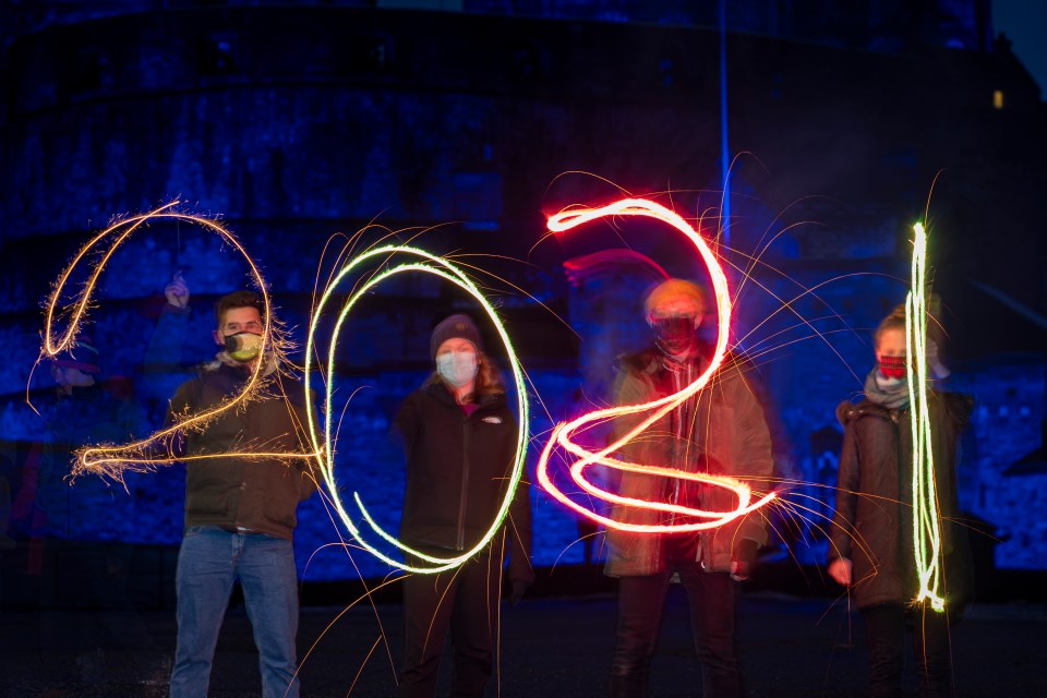 Pals use sparklers to display the year 2021 on Edinburgh Castle’s esplanade in Scotland