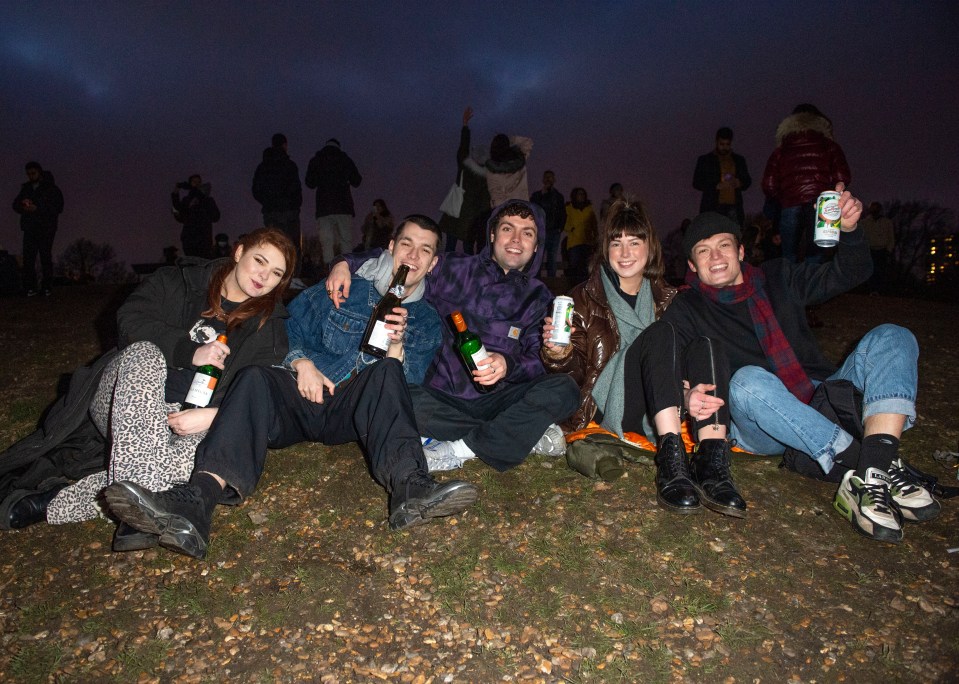 Pals celebrate the New Year on Primrose Hill in Central London