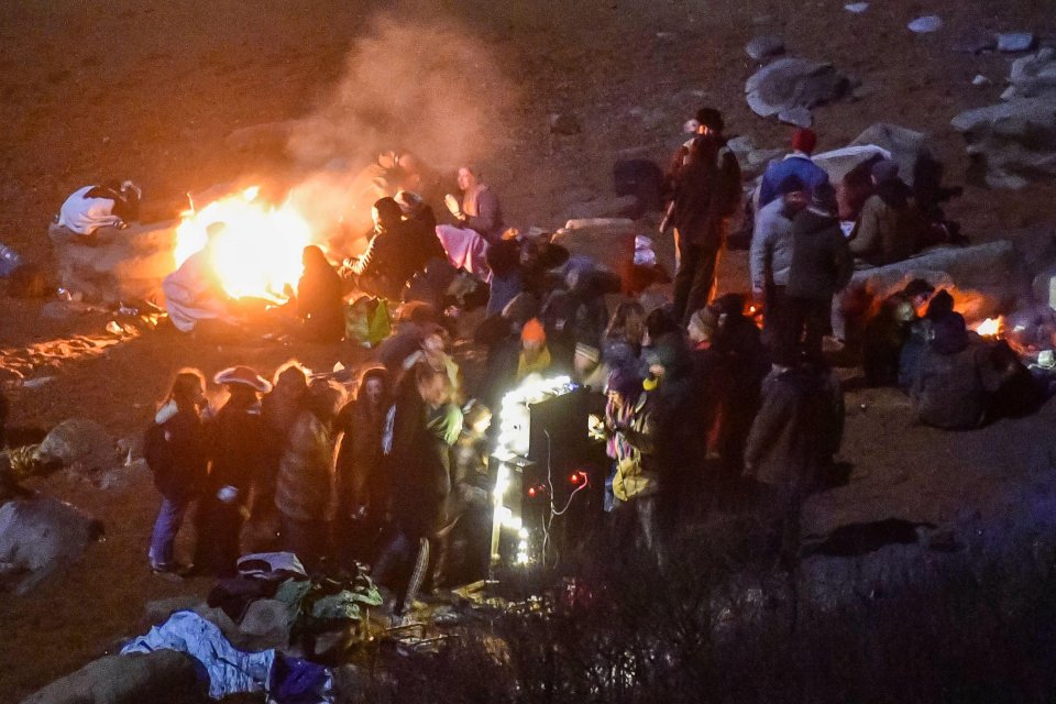 A large group of New Years Eve revellers have a party on the beach at Eype in Dorset