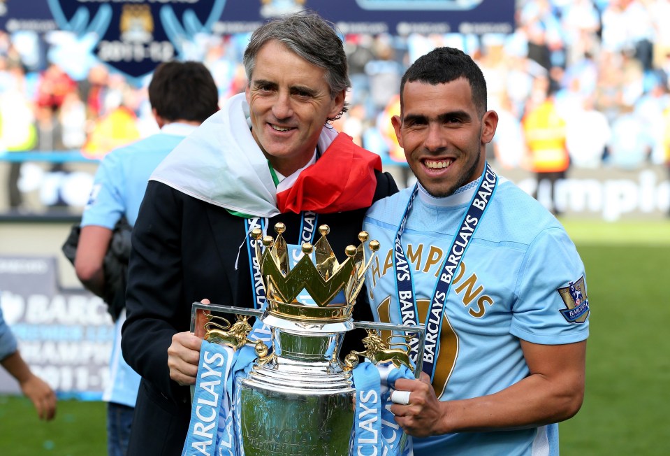 Roberto Mancini and Carlos Tevez pictured with the Premier League trophy