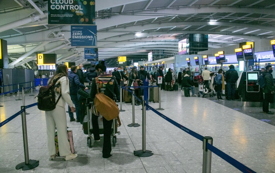 Passengers are seen at Heathrow Airport yesterday as Holland announced a travel ban from those coming in from the UK