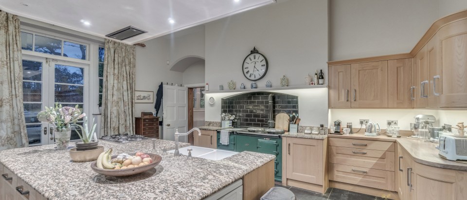 There are also plenty of modern touches, including granite work surfaces alongside a more traditional Aga 