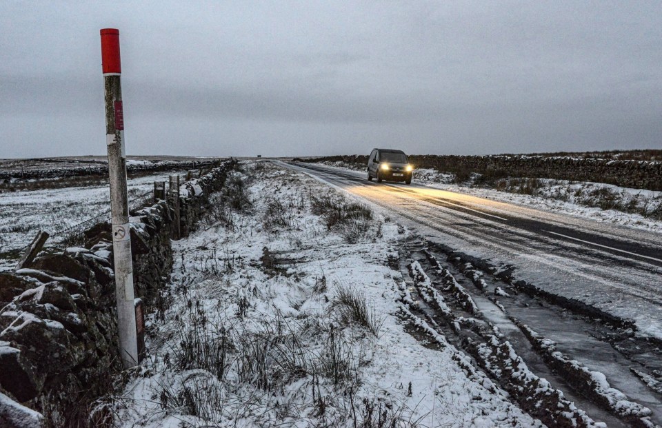 A car struggles to navigate the icy roads in Northumberland