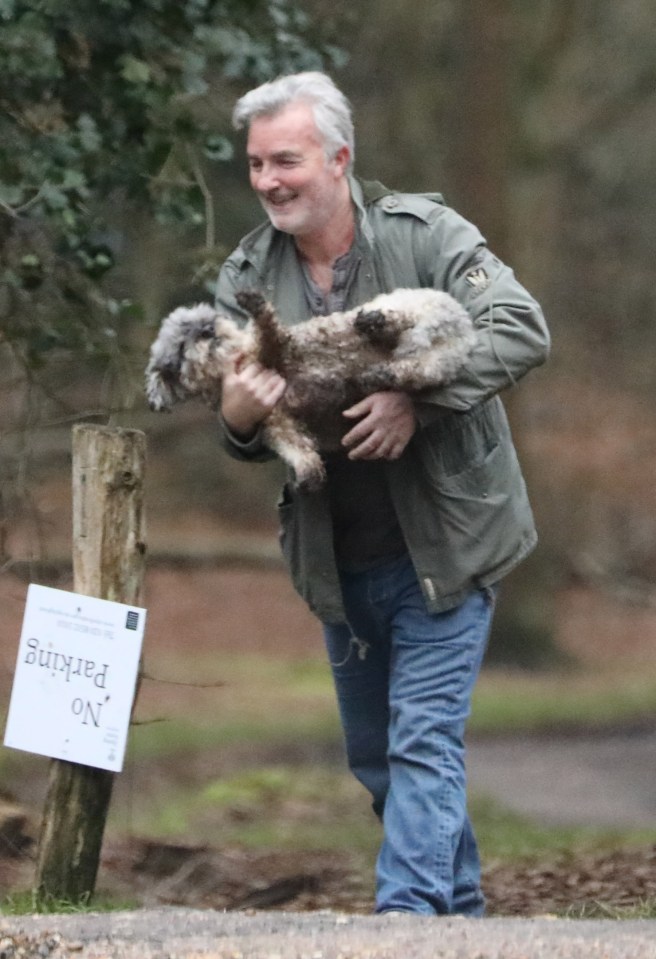 Nick Berry was seen walking - or, more accurately, carrying - his dog