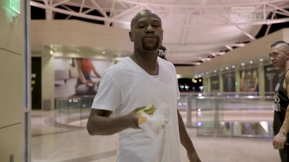 Floyd Mayweather chomps on a burger