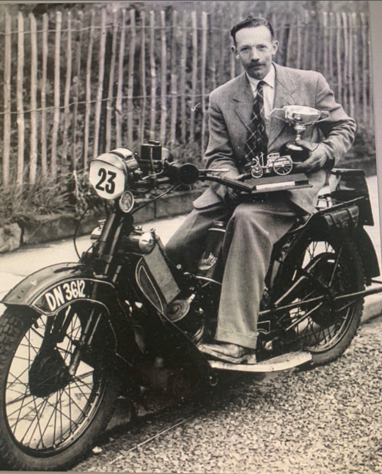 An undated picture shows Captain Tom pose with trophies on a motorcycle 