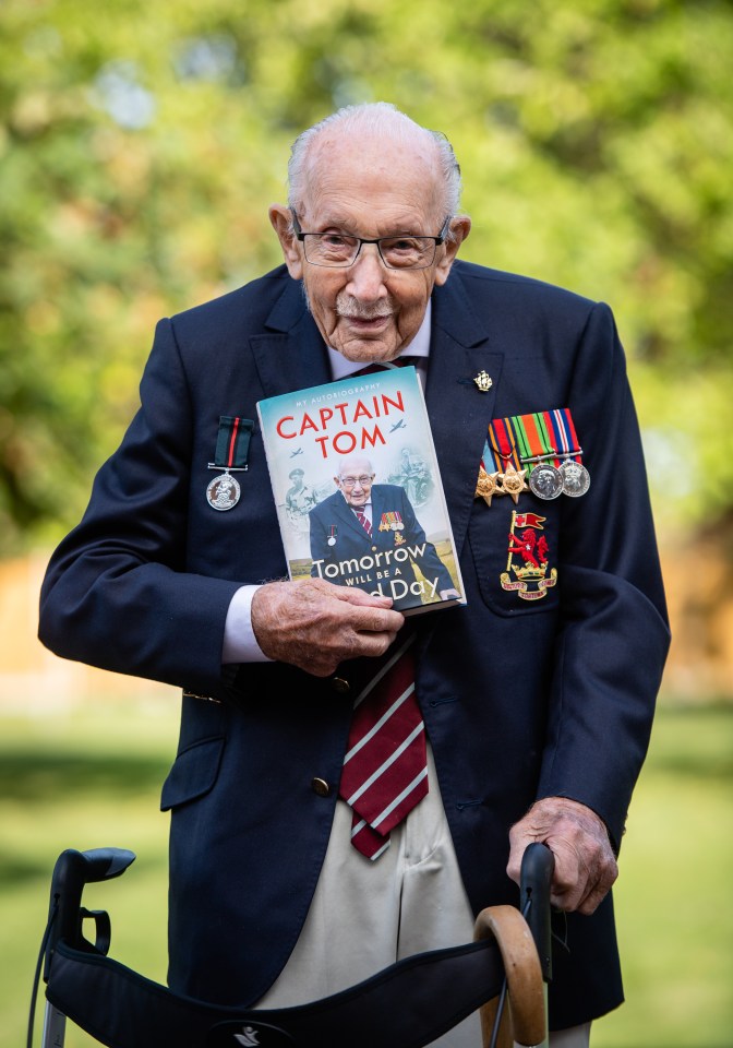 Captain Sir Tom poses with his memoir he released in September called 'Tomorrow Will Be A Good Day'