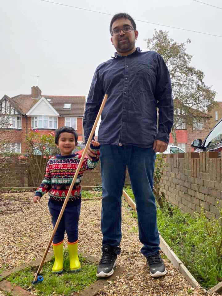 Sandun and his son Kevin stand next to the huge stick that fell from the sky