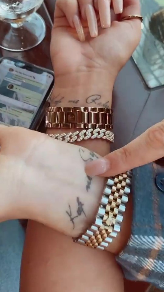 Chloe's tattoo says "keep me safe" in a cursive font on her wrist. Her pal's matching tattoo says: "Keep me radging"