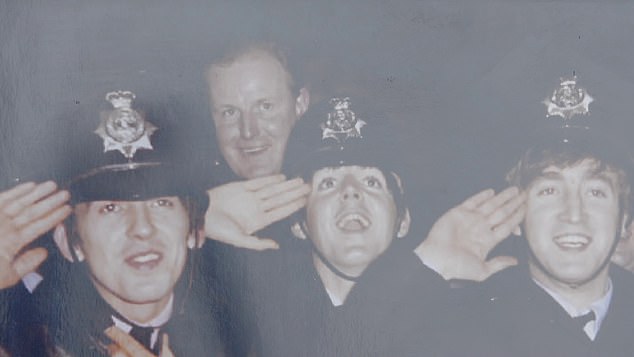 John Lennon, far right, sported police officer Ivor Gordon Russell's police helmet before a show in 1963