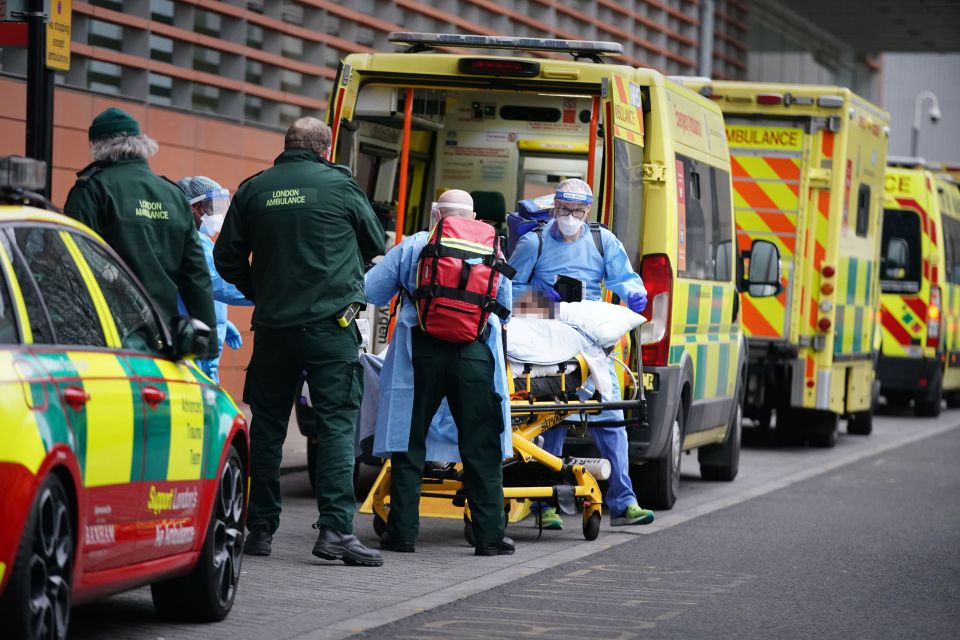 Paramedics unload a patient from an ambulance outside the Royal London Hospital in east London on January 8