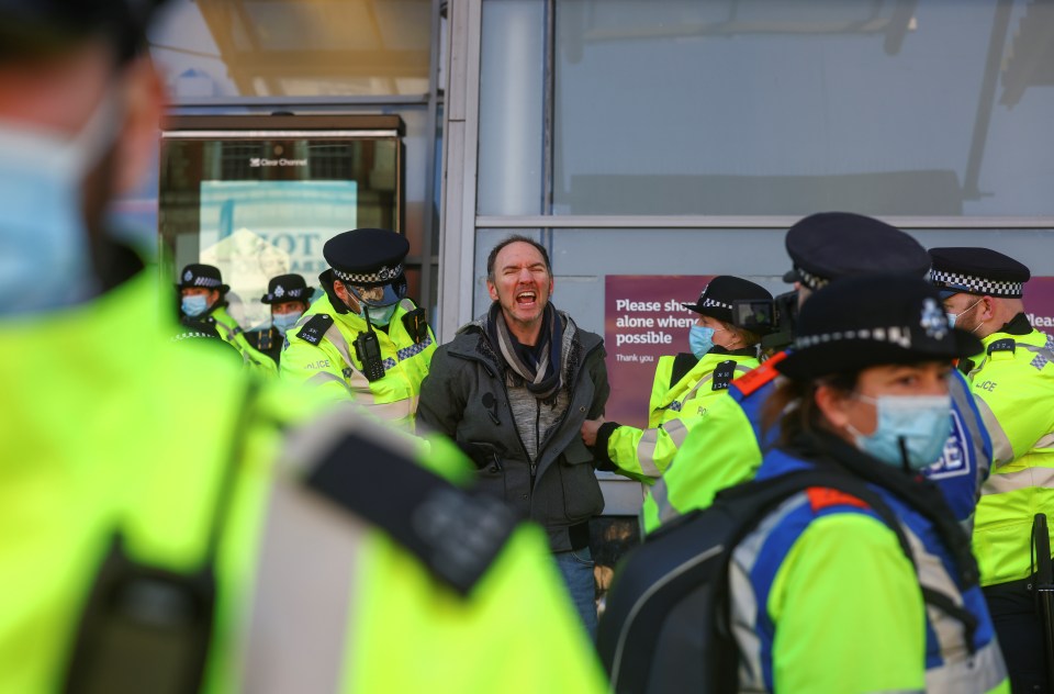 A man yells as he is arrested at the protest