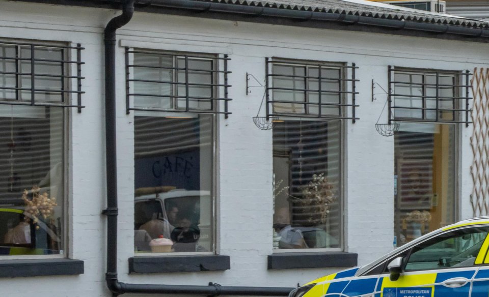 A picture shows a group of officers appearing to flout Covid rules by eating breakfast in a cafe