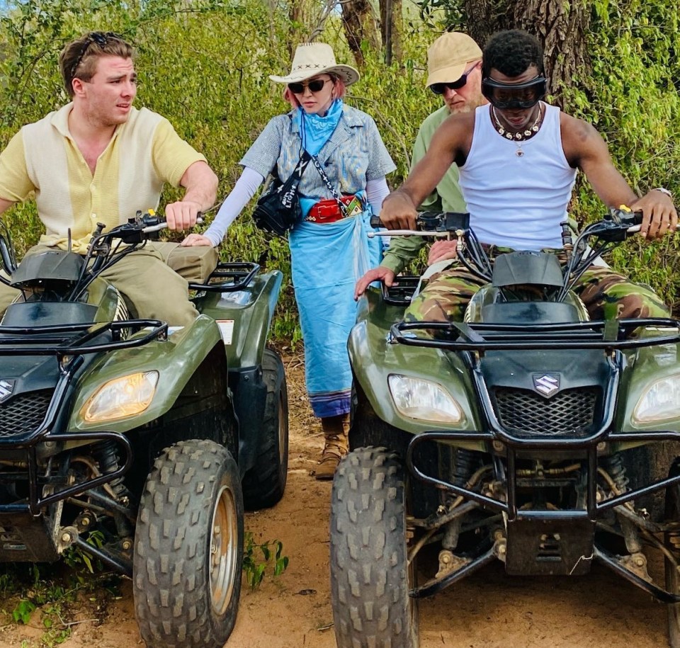 Madonna with sons Rocco, left, and David as they cruise along on quad  bikes