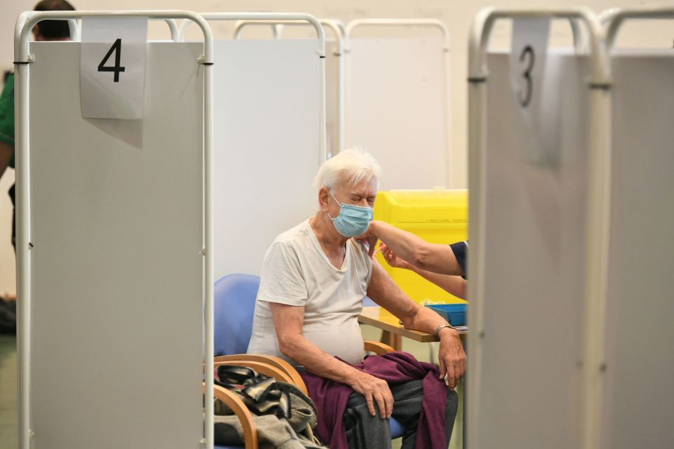 Before getting your jab you will have a health check. One man is seen having his jab in Surrey this morning 