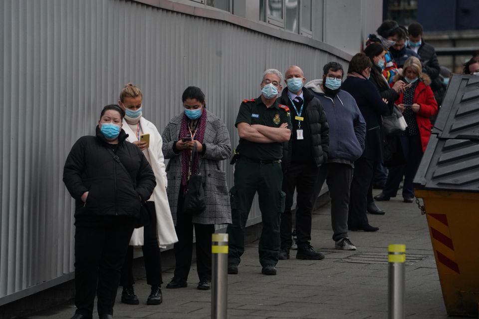 People are seen lining up in Newcastle, wearing face masks as they wait for their jab this morning. NHS workers and paramedics are seen in the queue