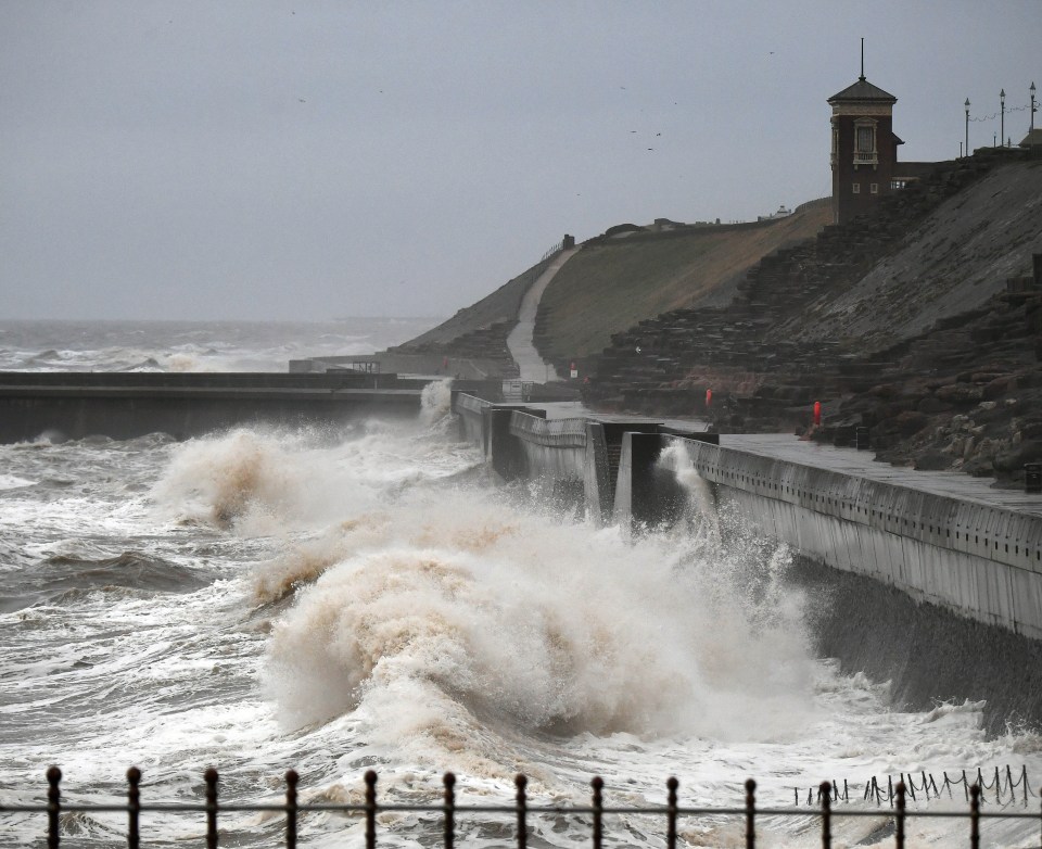 Waves strike the promenade at Blackpool today in cold weather