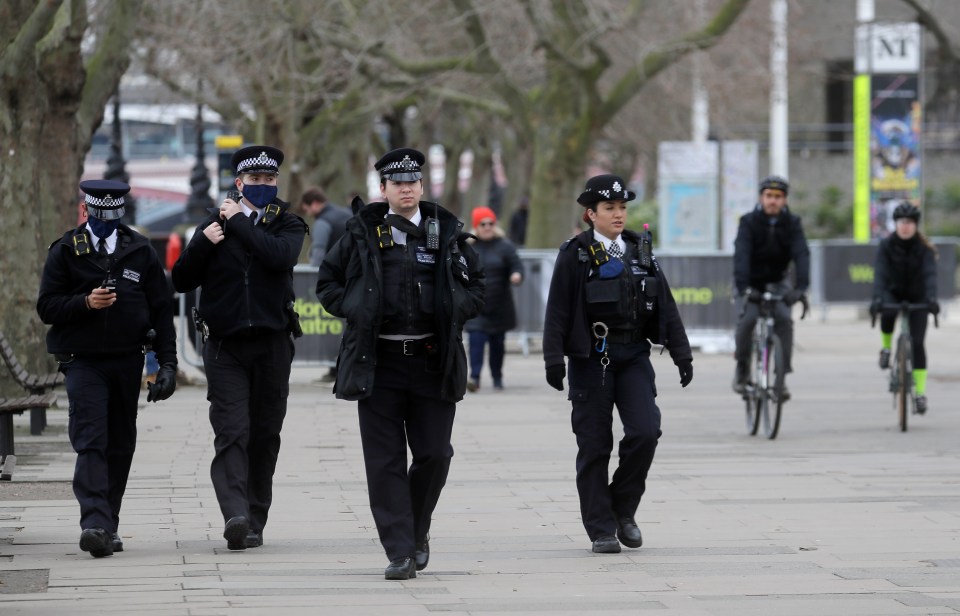 Police officers patrol the South Bank in London yesterday morning as cops vowed to crack down on Brits flouting the rules