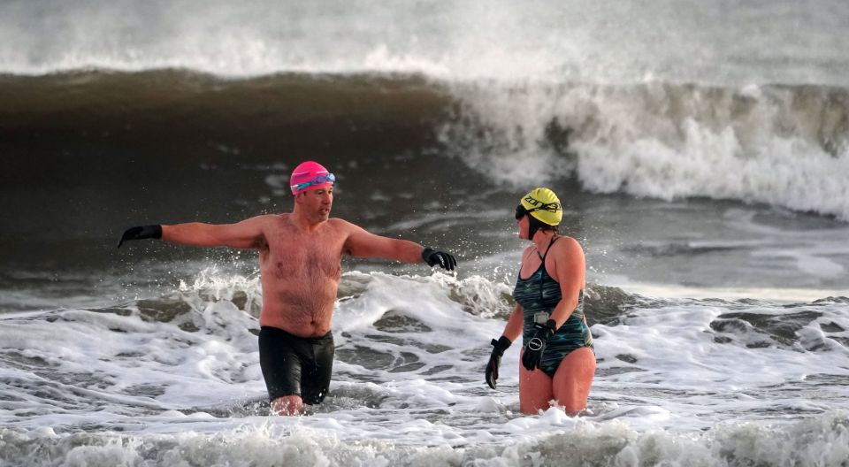 Two brave swimmers took on the choppy waters as they went in for a dip in North Tyneside