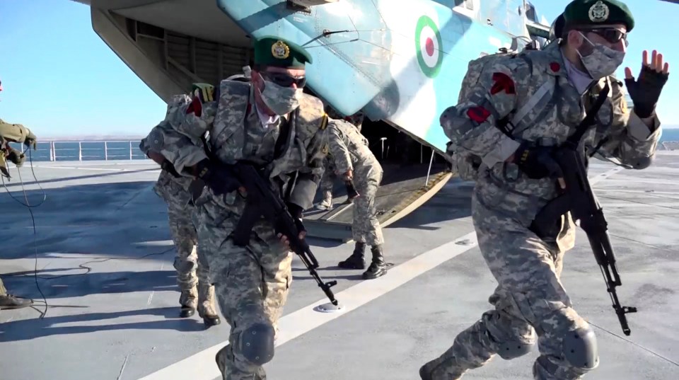 Aerial troops step onto the deck of Iran's newest warship Makran today