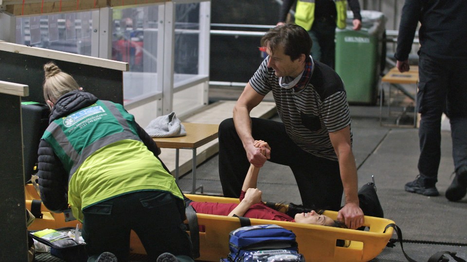 Graham Bell held Yebin's hand as she was stretchered off the ice