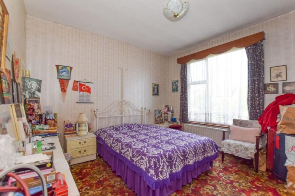 Perhaps not the most soothing of colours in this bedroom, the Cadbury purple bedding is certainly an acquired taste