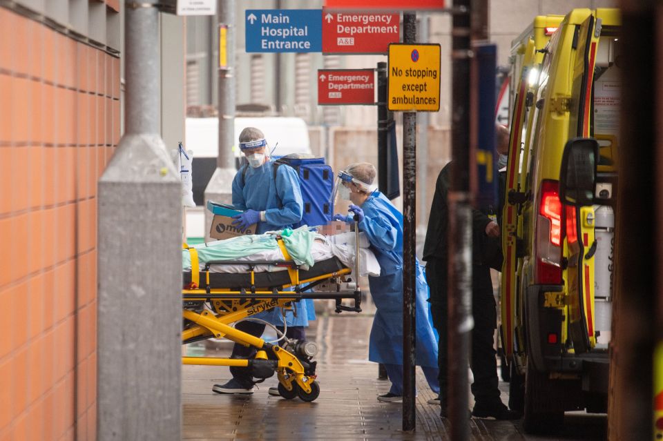 Paramedics unload a patient from an ambulance outside the Royal London Hospital in London